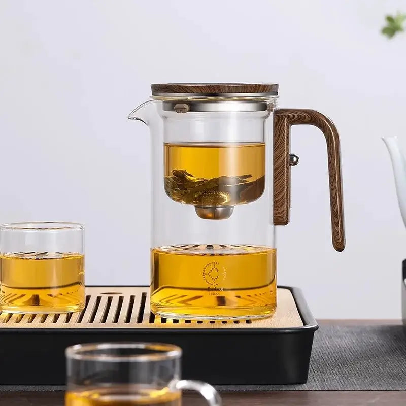 Elegant glass teapot with magnetic infuser, brewing loose leaf tea, showcasing smooth infusion.