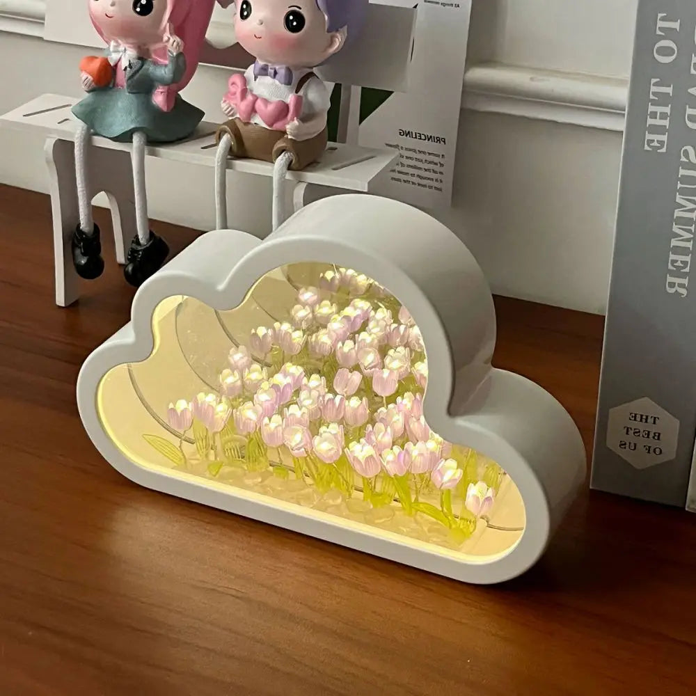 Cloud Tulip Infinity Night Light features tulip flowers in a cloud-shaped design, illuminated softly on a wooden table.