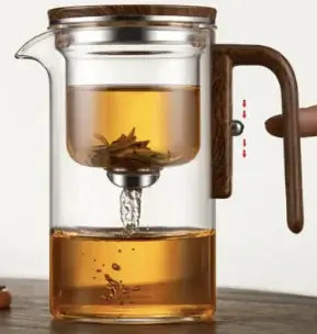 Elegant glass teapot with magnetic infuser, brewing loose leaf tea, showcasing fine mesh strainer and stylish design.