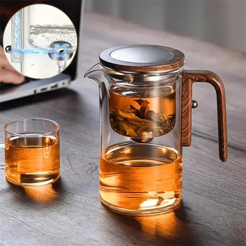 Elegant glass teapot with magnetic tea infuser, showcasing loose leaf tea brewing and a stylish glass design.